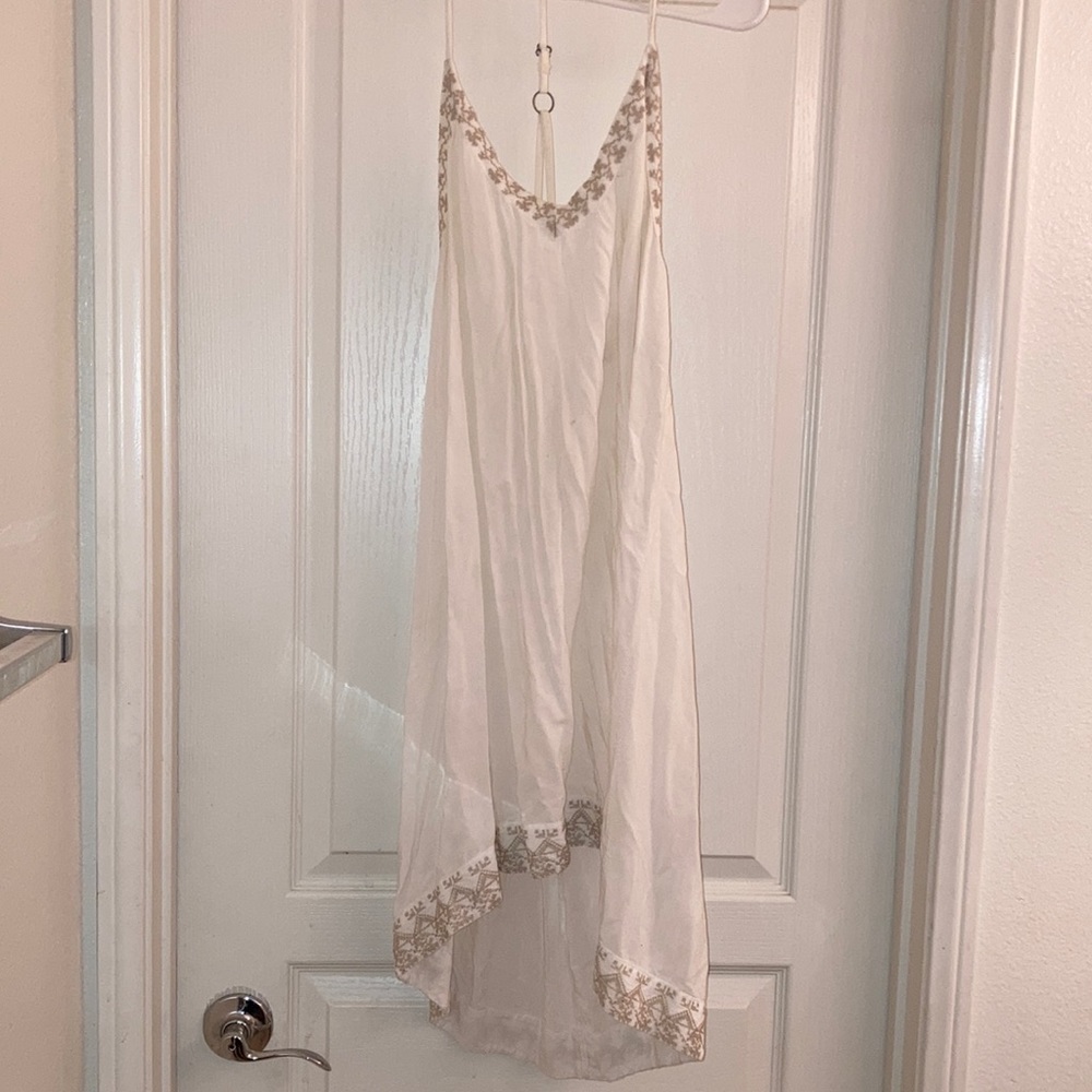 White dress with brown stitching
